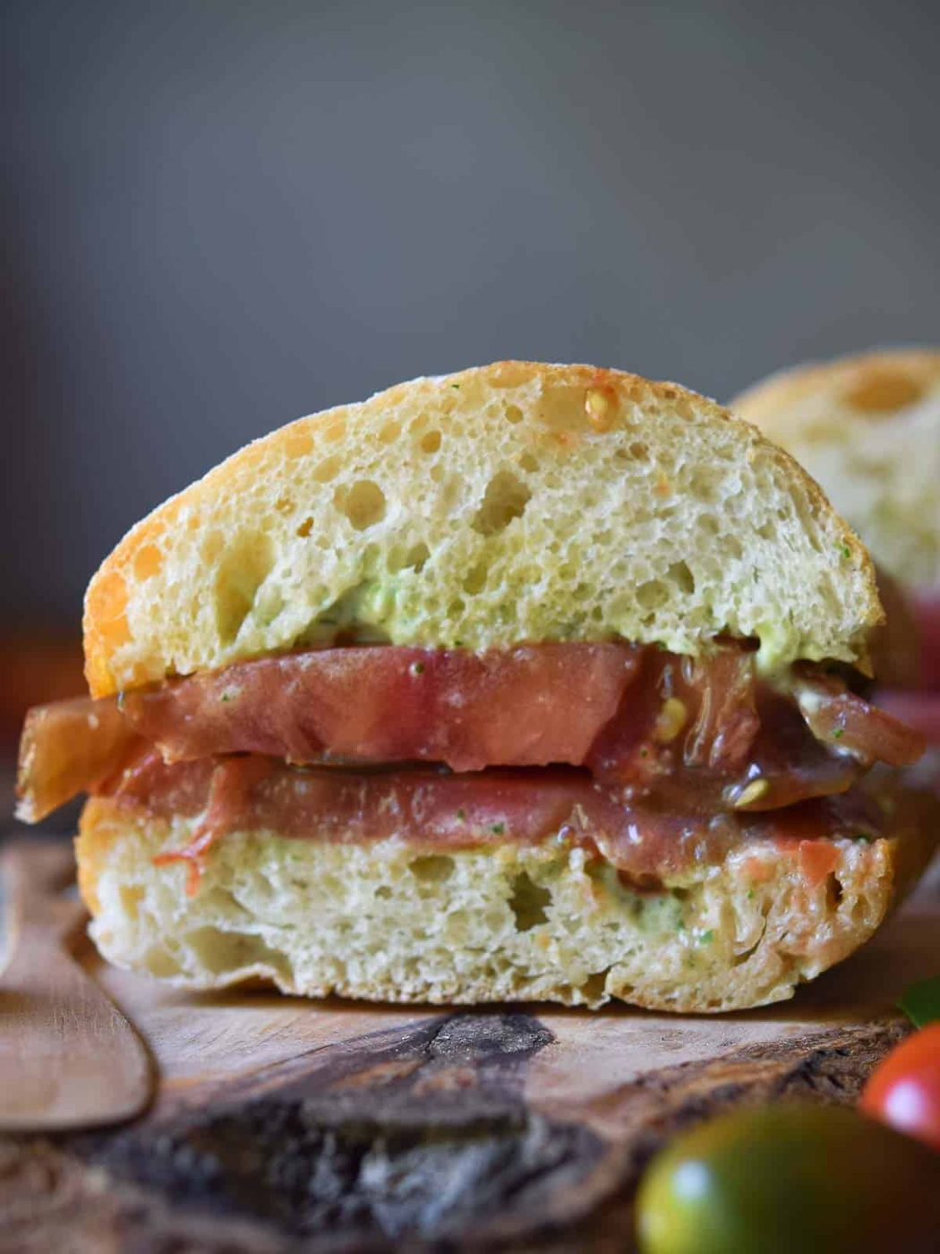 Close-up of a tomato ciabatta sandwich cut open.