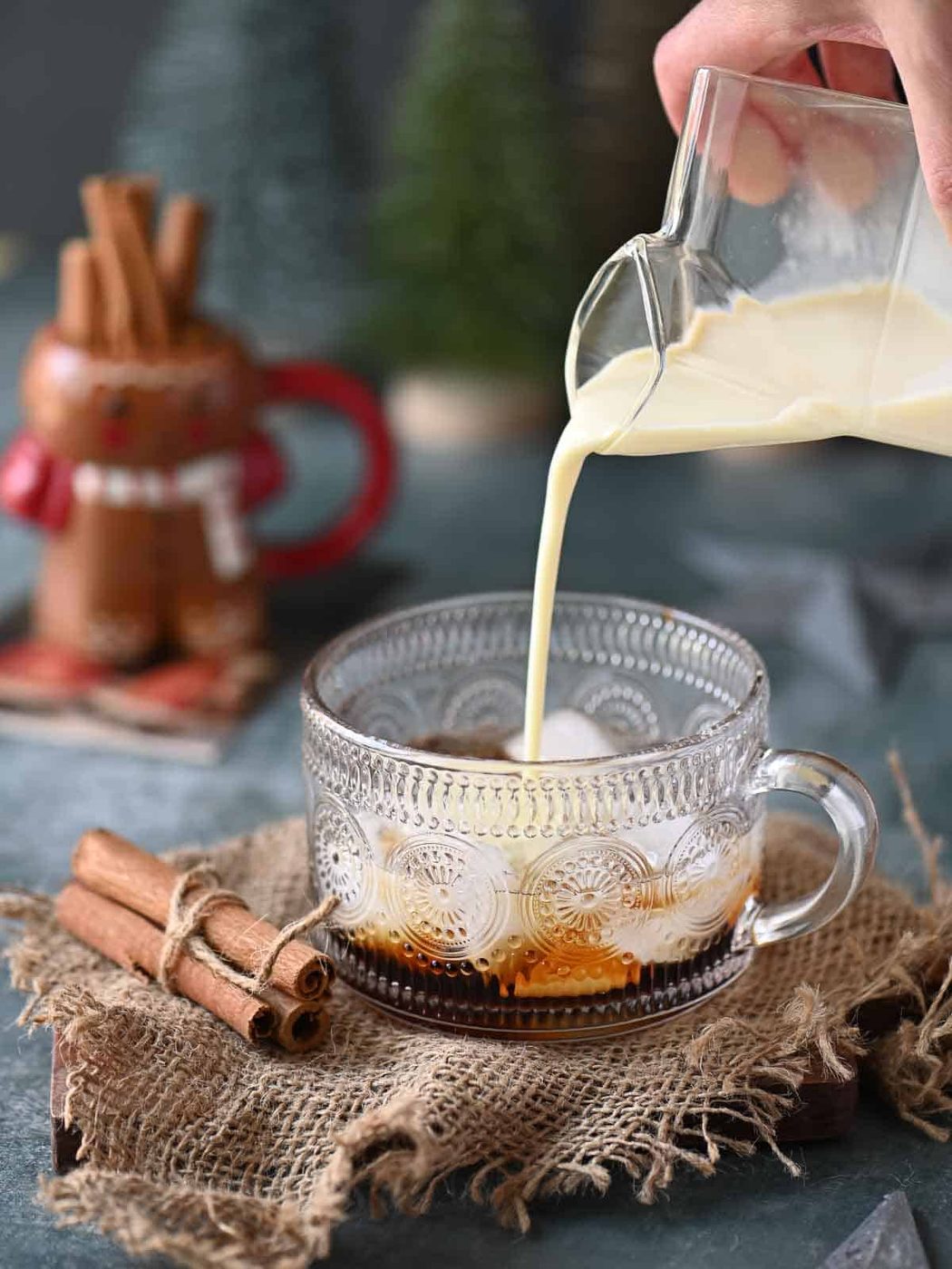 Eggnog being poured into a clear class.