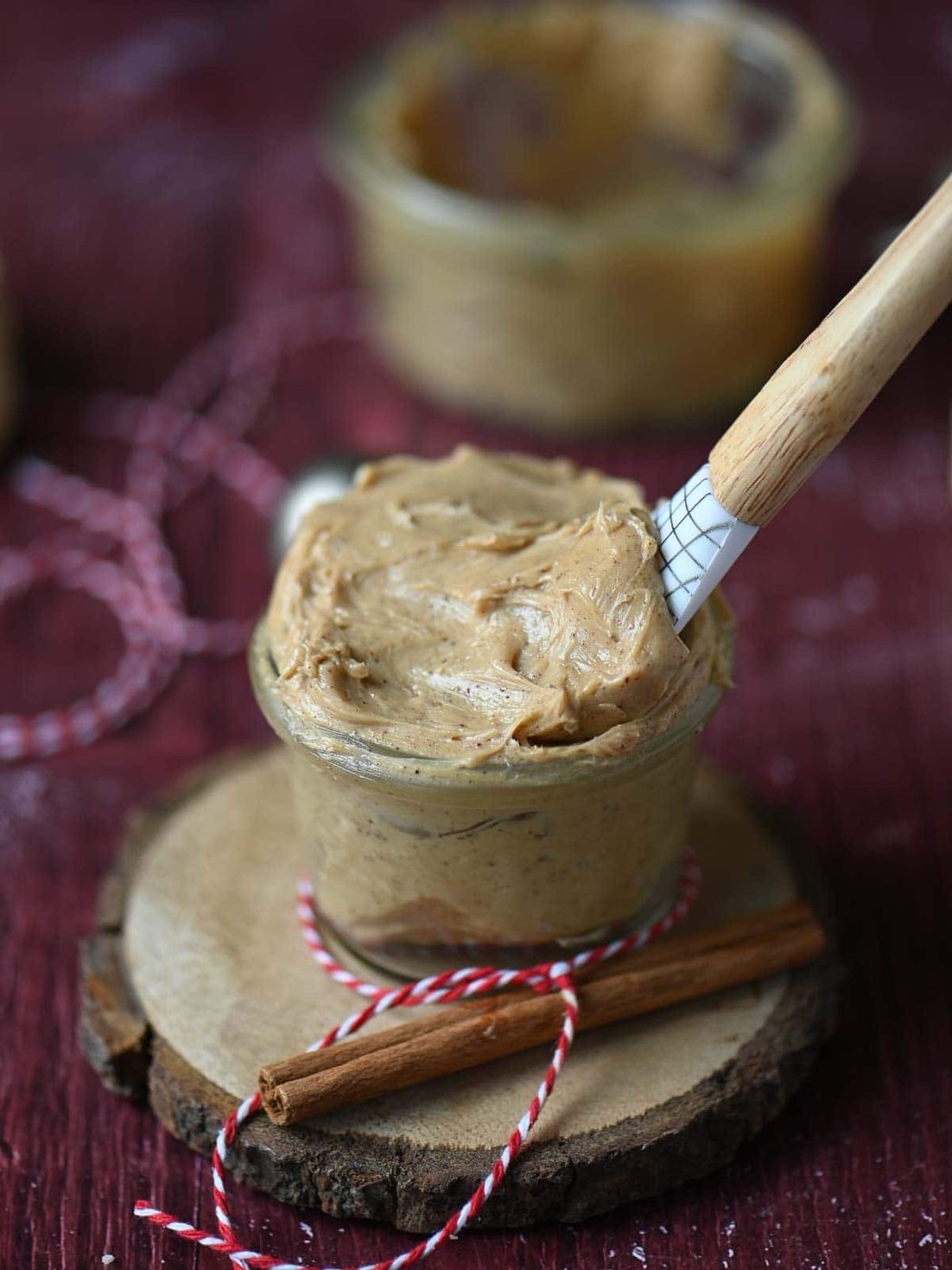 Creamy butter in a jar with a spatula in it.
