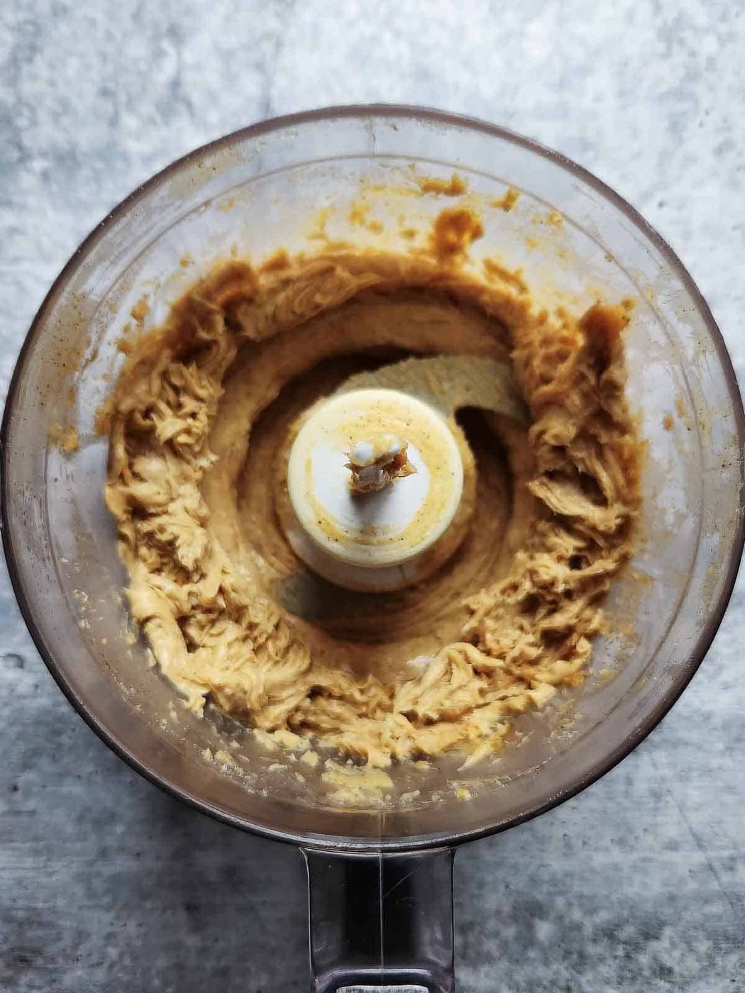 Overhead of whipped butter in a small food processor.