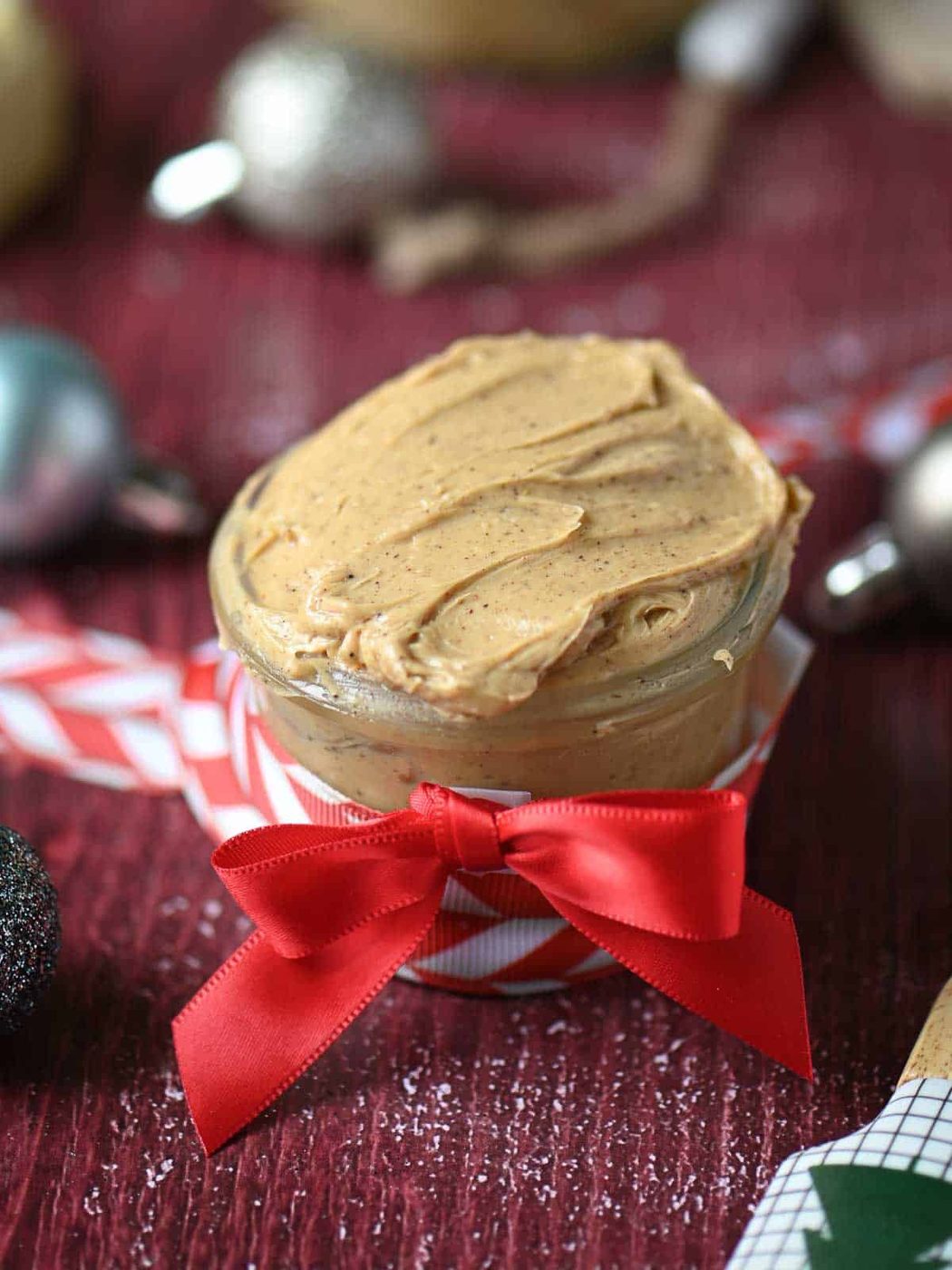 Gingerbread butter in a clear jar with red ribbon.