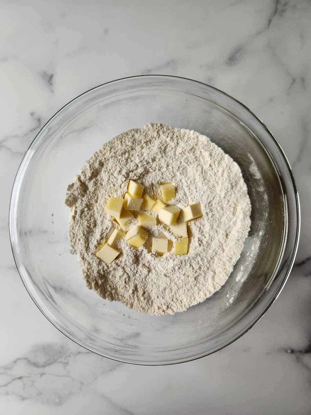 Cubed butter with flour to make scones.