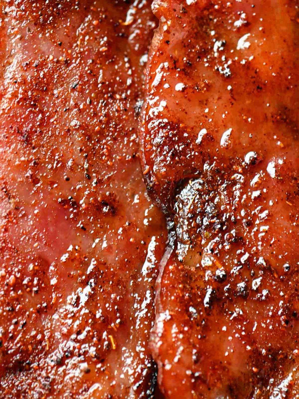 Close-up of caramelized bacon with a glossy glaze, ready to serve.