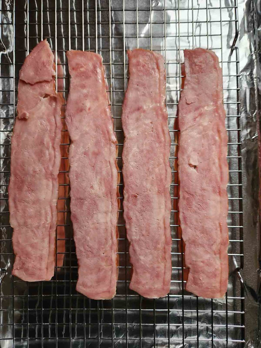 Turkey bacon on wire rack on top of a baking sheet.