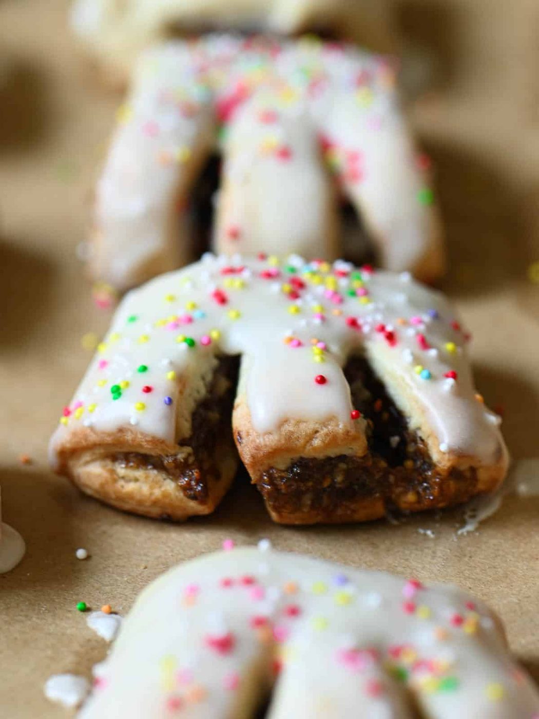 Close-up of a cuccidati cookie on parchment paper.