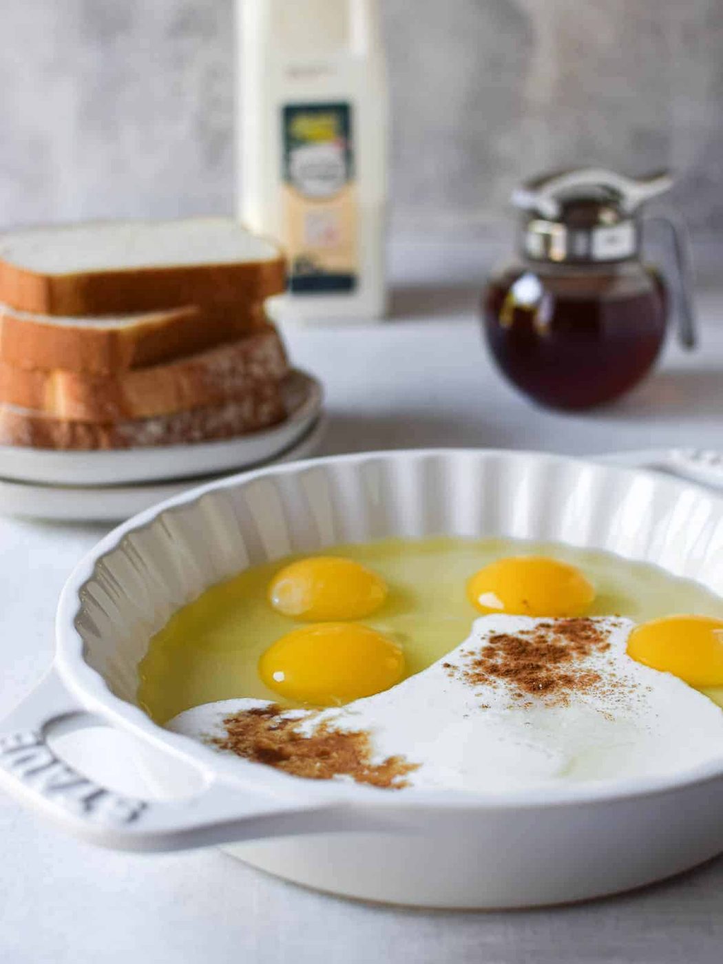 Custard for French toast in a white shallow bowl.