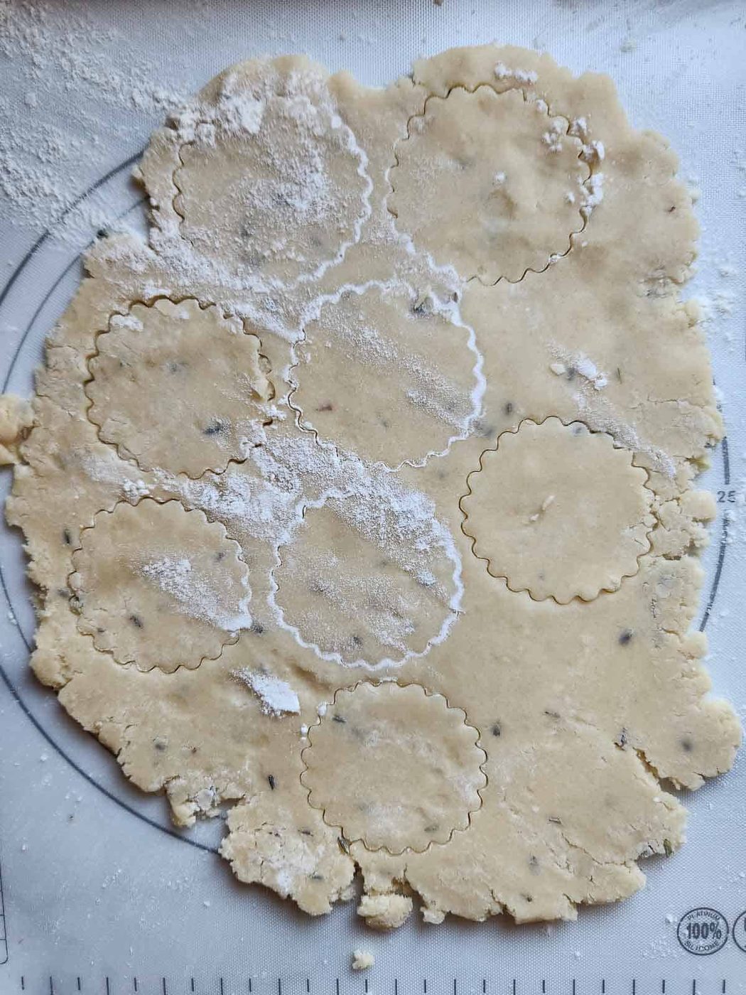 Lemon lavender shortbread dough cut out with a cookie cutter.