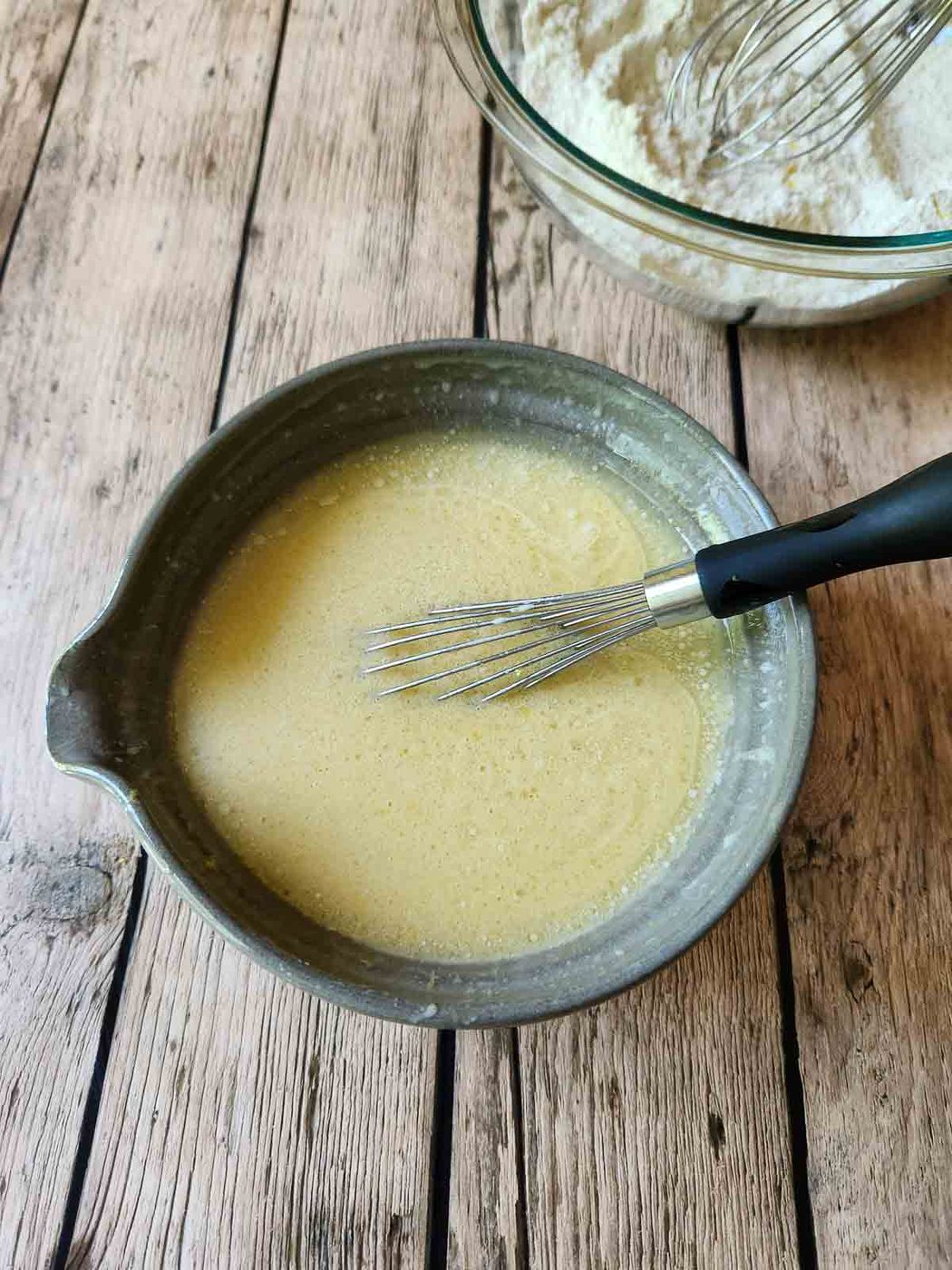 Liquid batter in a mixing bowl for muffins.