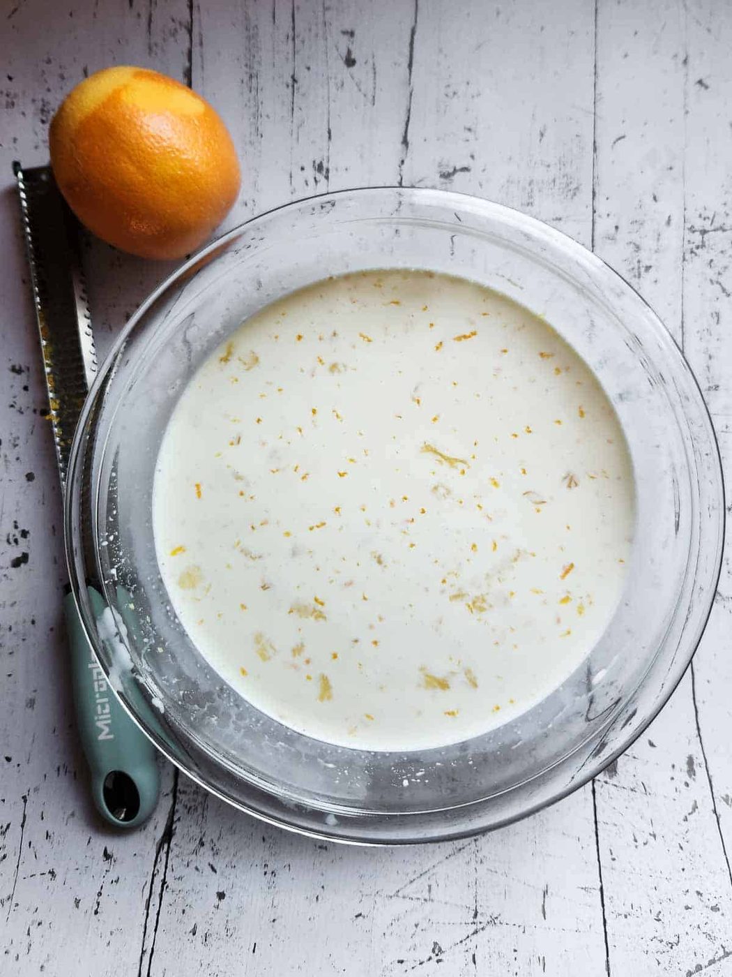 Custard mixture with orange zest for bread pudding.
