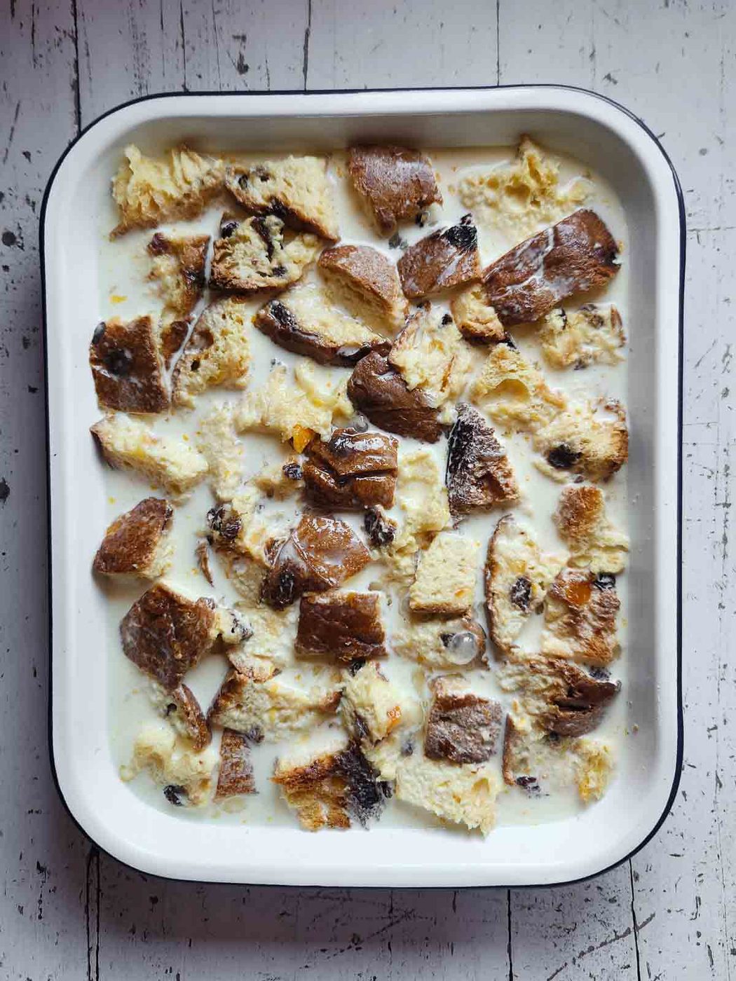 Panettone bread pudding in a baking pan before being cooked.