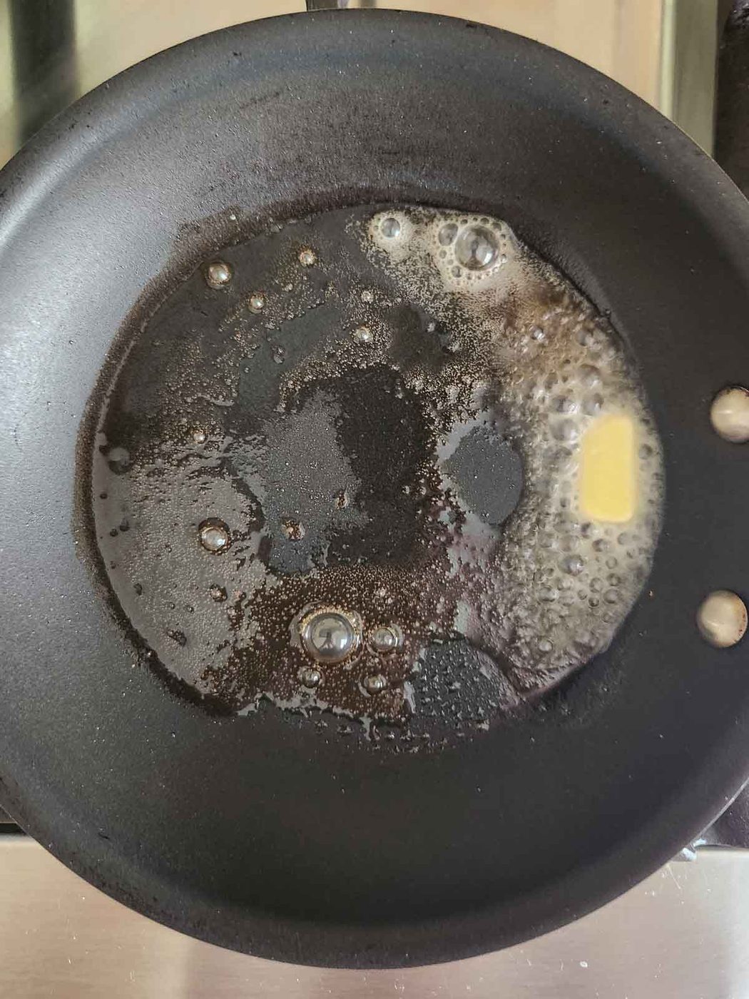 Butter foaming in a skillet.
