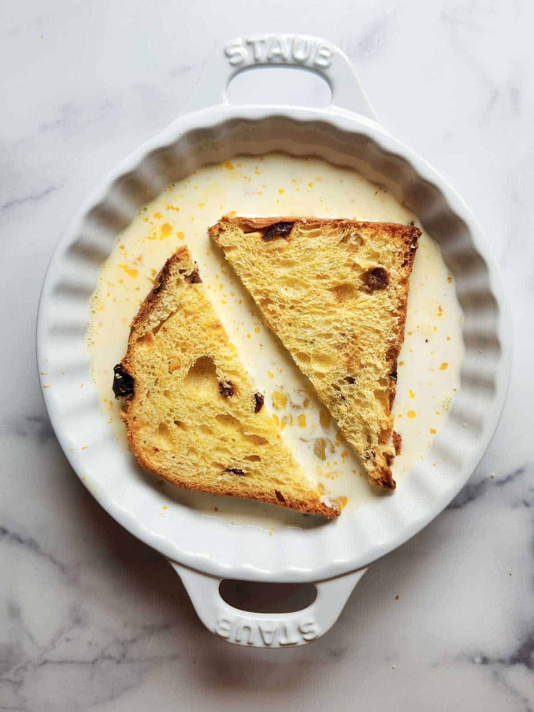 Panettone soaking in custard for French toast.