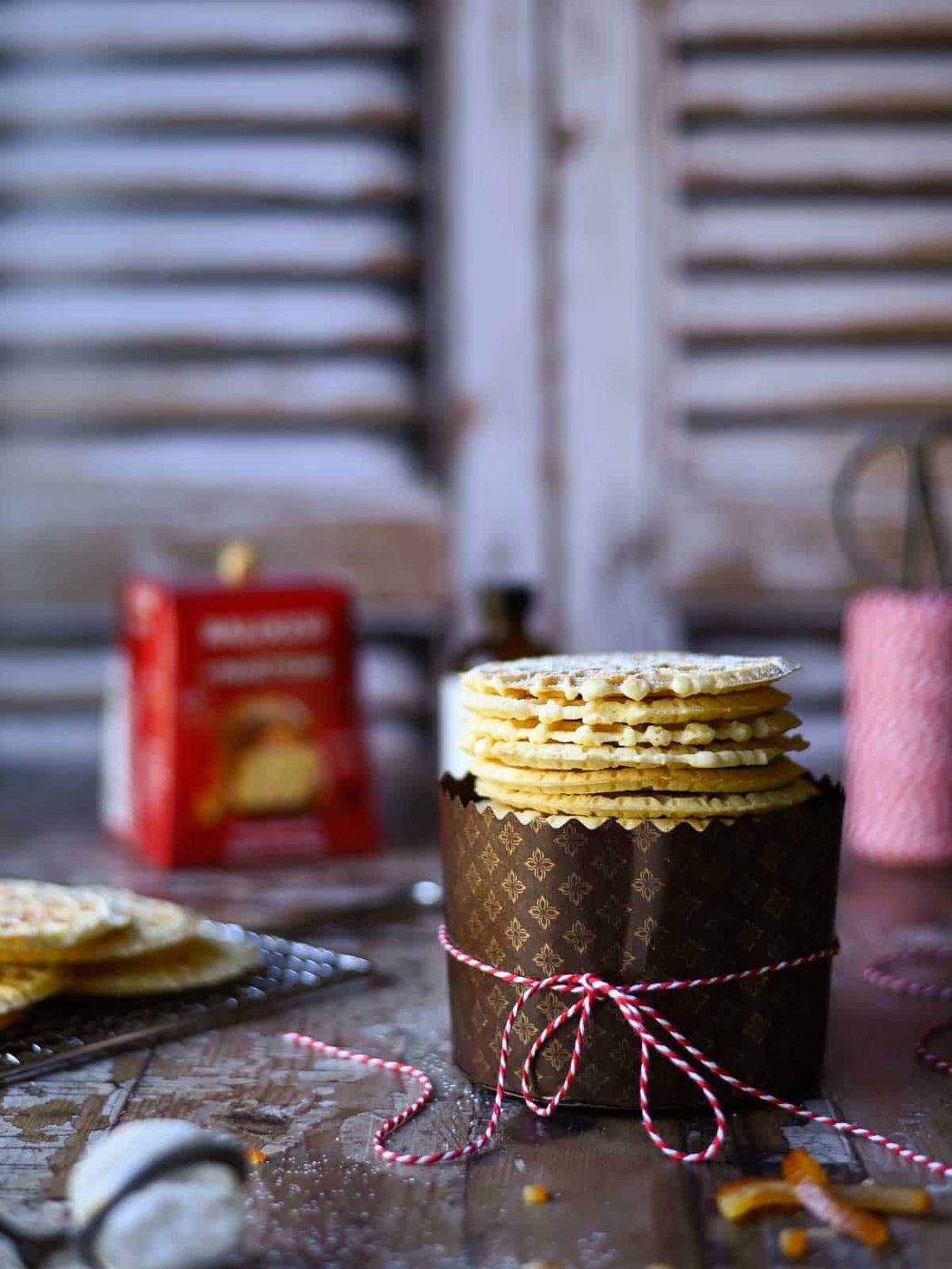 Eye level view of pizzelle in a panettone wrapper.