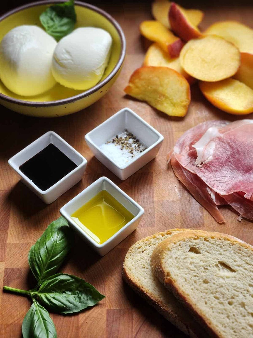 Ingredients for a peach panini on a cutting board.