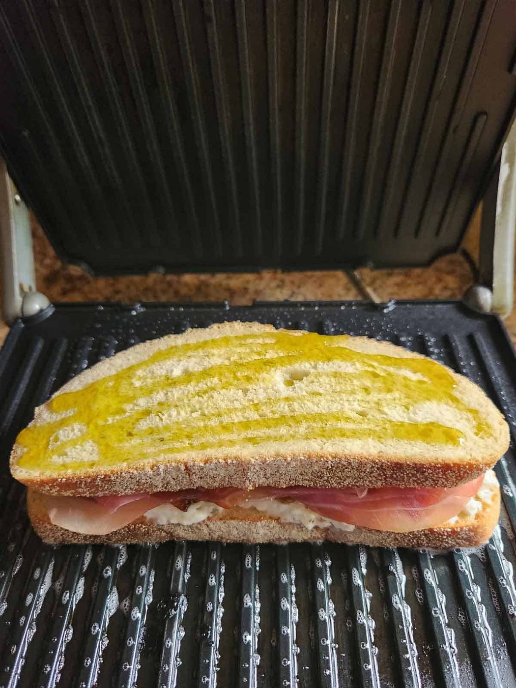 A peach panini on an electric panini maker.