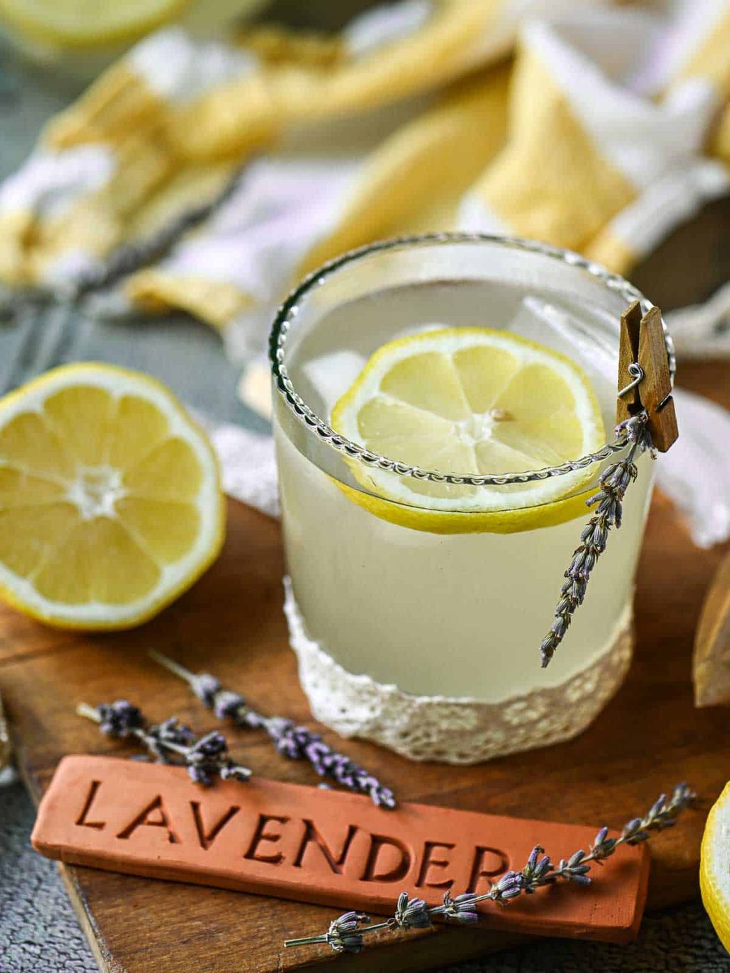 Lavender lemonade in a glass with lemon slices and lavender.