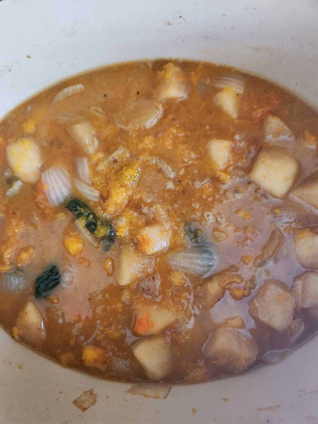 Vegetables and stock in a pot for soup.