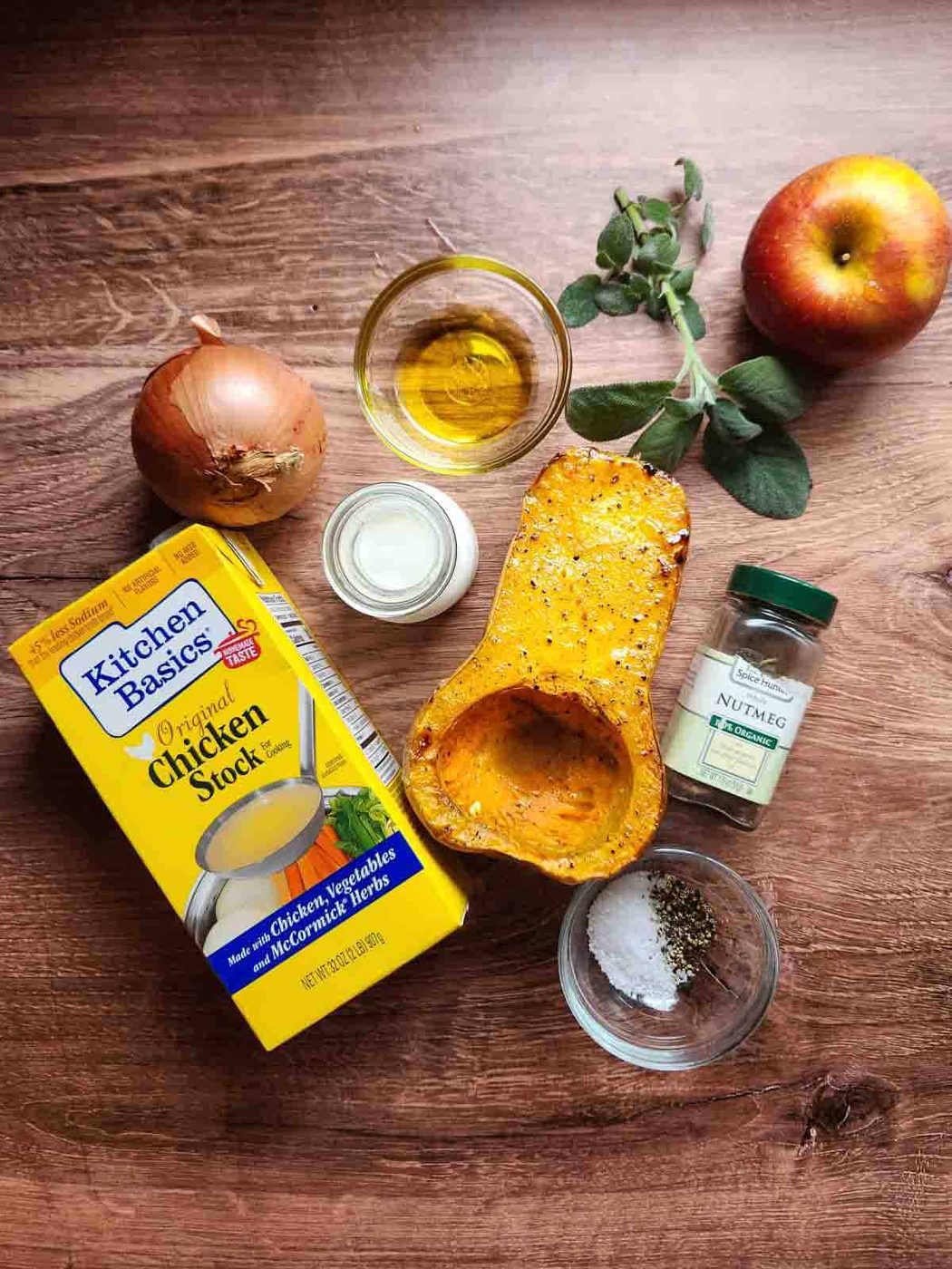 Ingredients for squash soup on a wooden background.