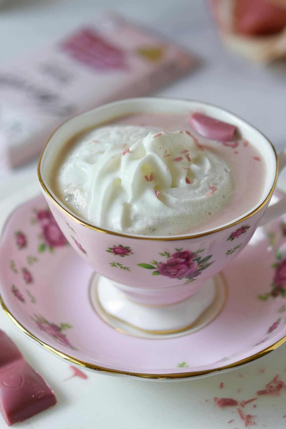 Overhead view of pink hot chocolate with whipped cream.