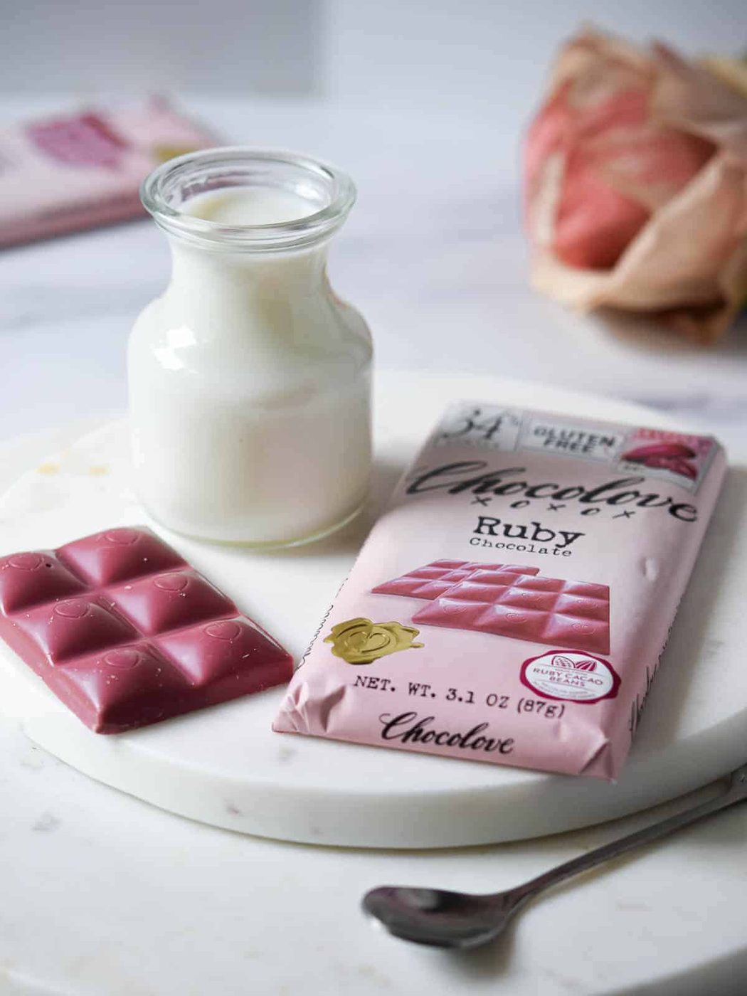 Ingredients for ruby hot chocolate on white marble board.