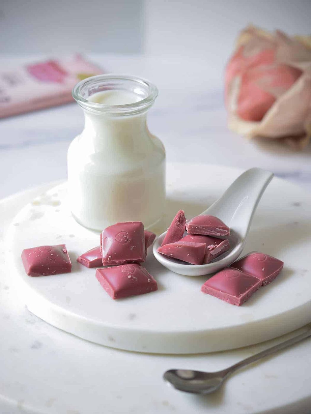 Ingredients for ruby hot chocolate on a marble board.