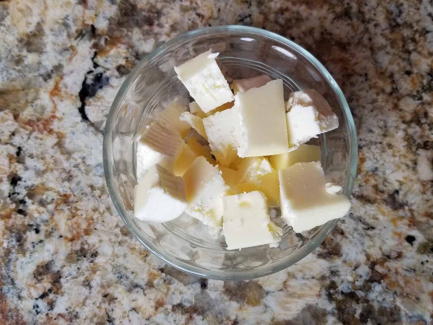 Cubed butter ingredient in a clear bowl.