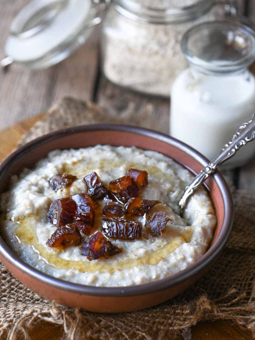 Oatmeal with dates and honey in a brown bowl.