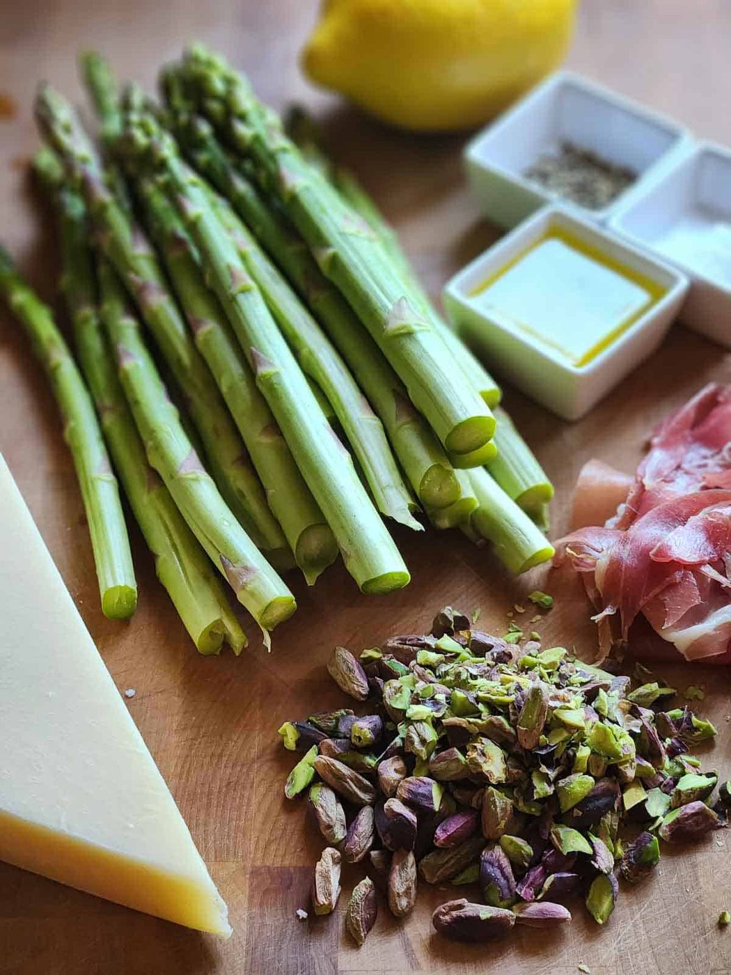 Ingredients for shaved asparagus salad on a cutting board.