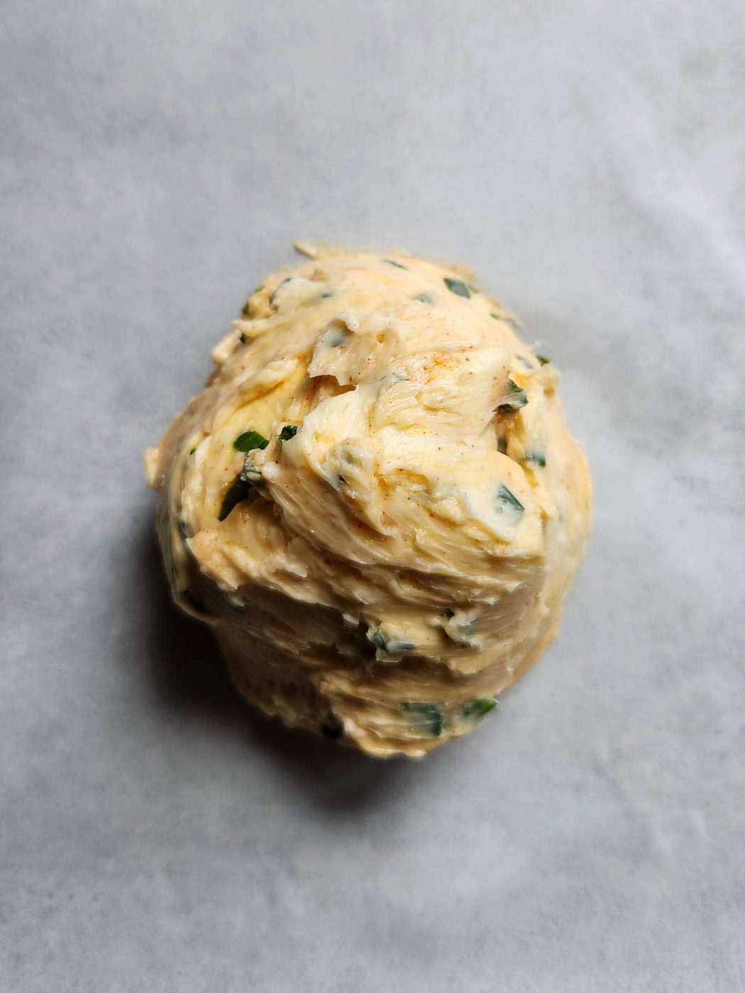 Chive butter on parchment paper.