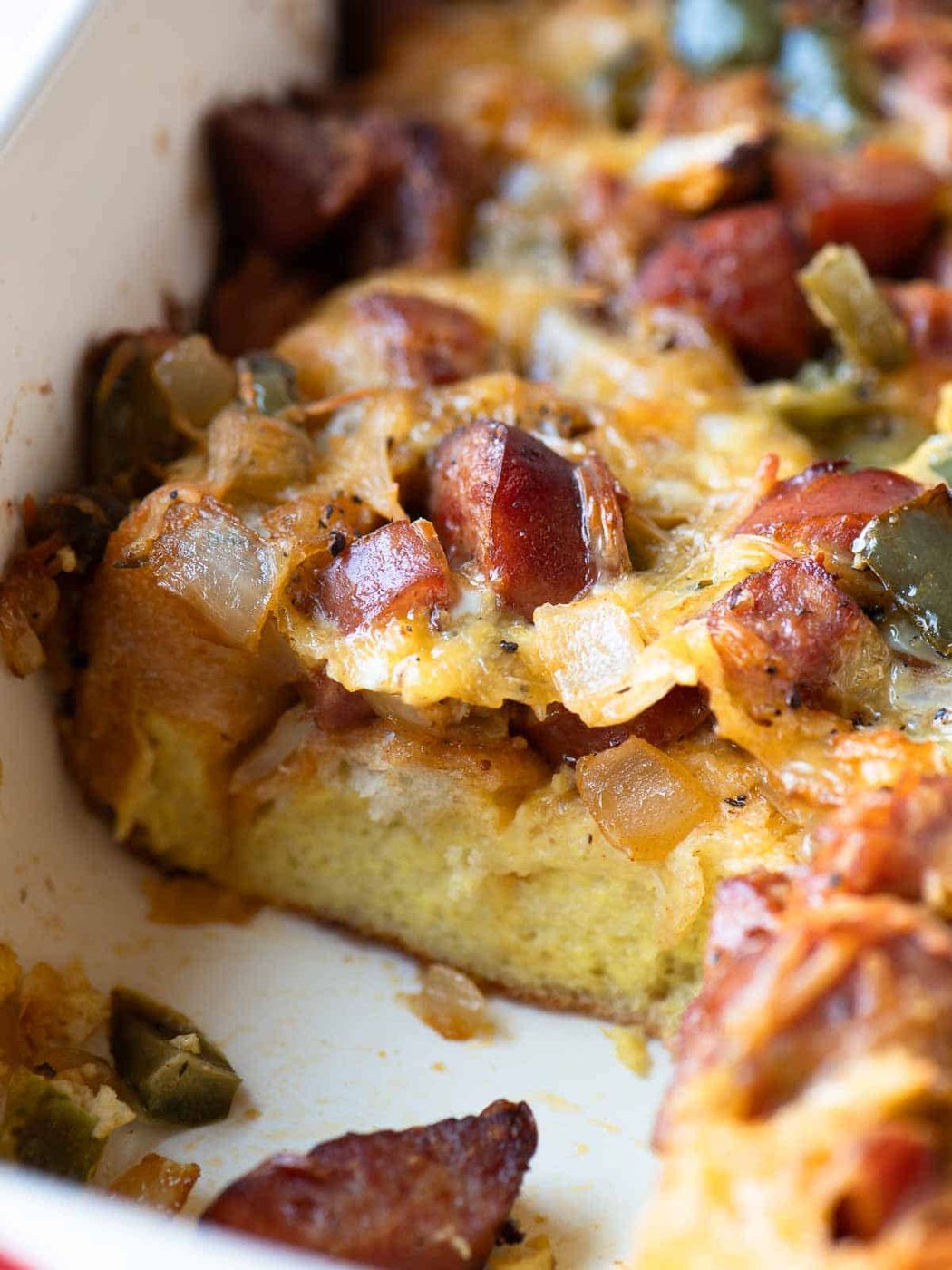 Close-up of a smoked sausage strata in a casserole dish.
