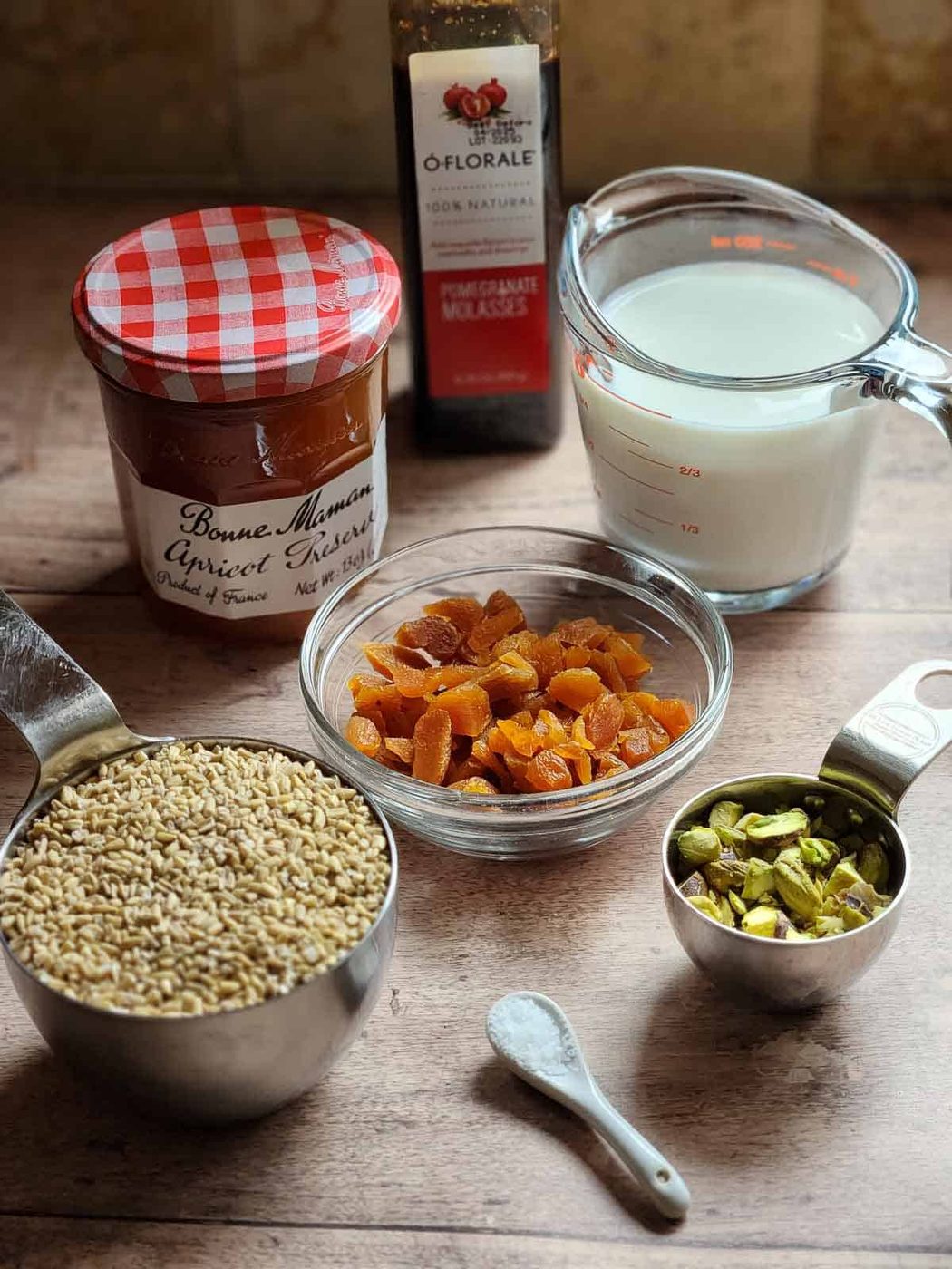 Ingredients for apricot oatmeal on a wood surface.