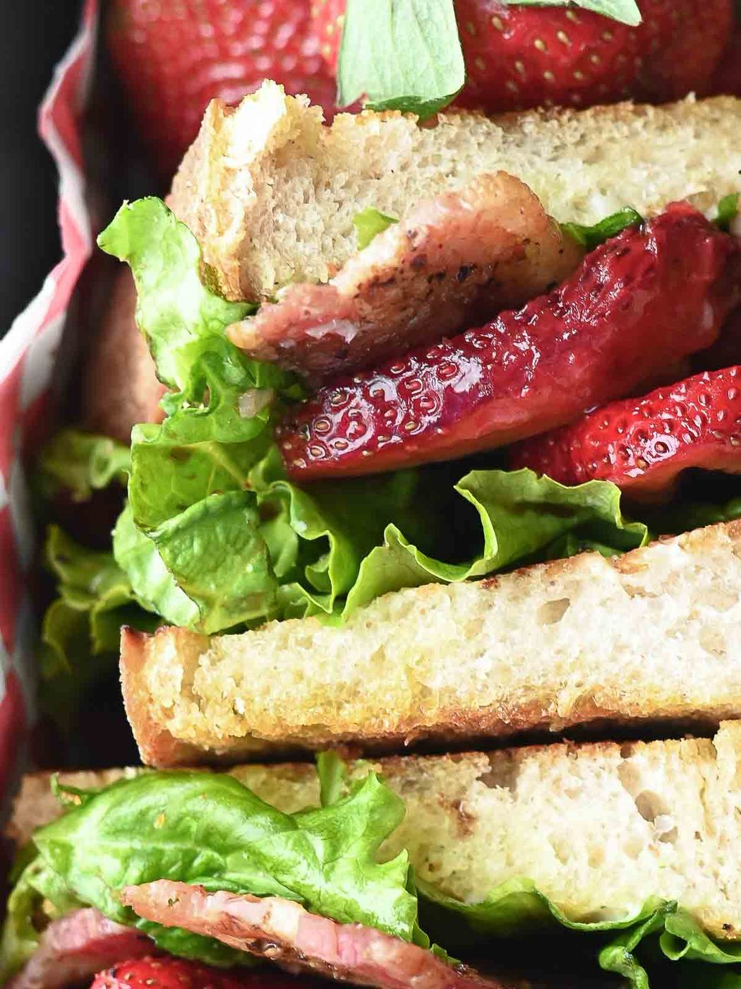Overhead close-up of a strawberry BLT sandwhich.