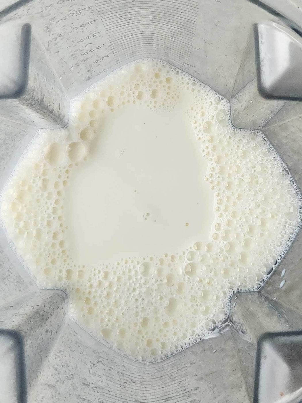 Overhead of milk in a blender.