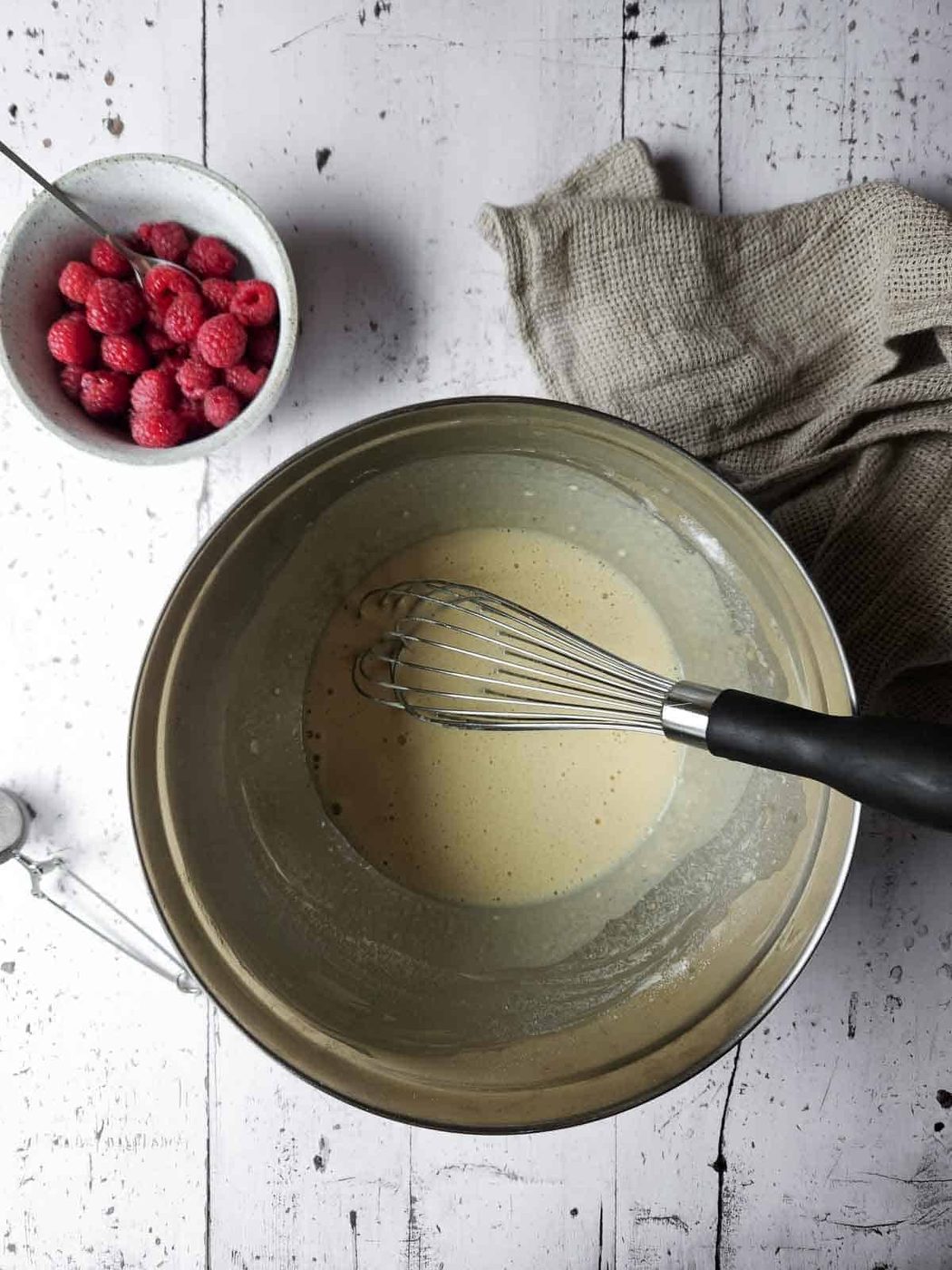 Mixed batter for sweet vanilla Dutch Baby in a metal bowl.