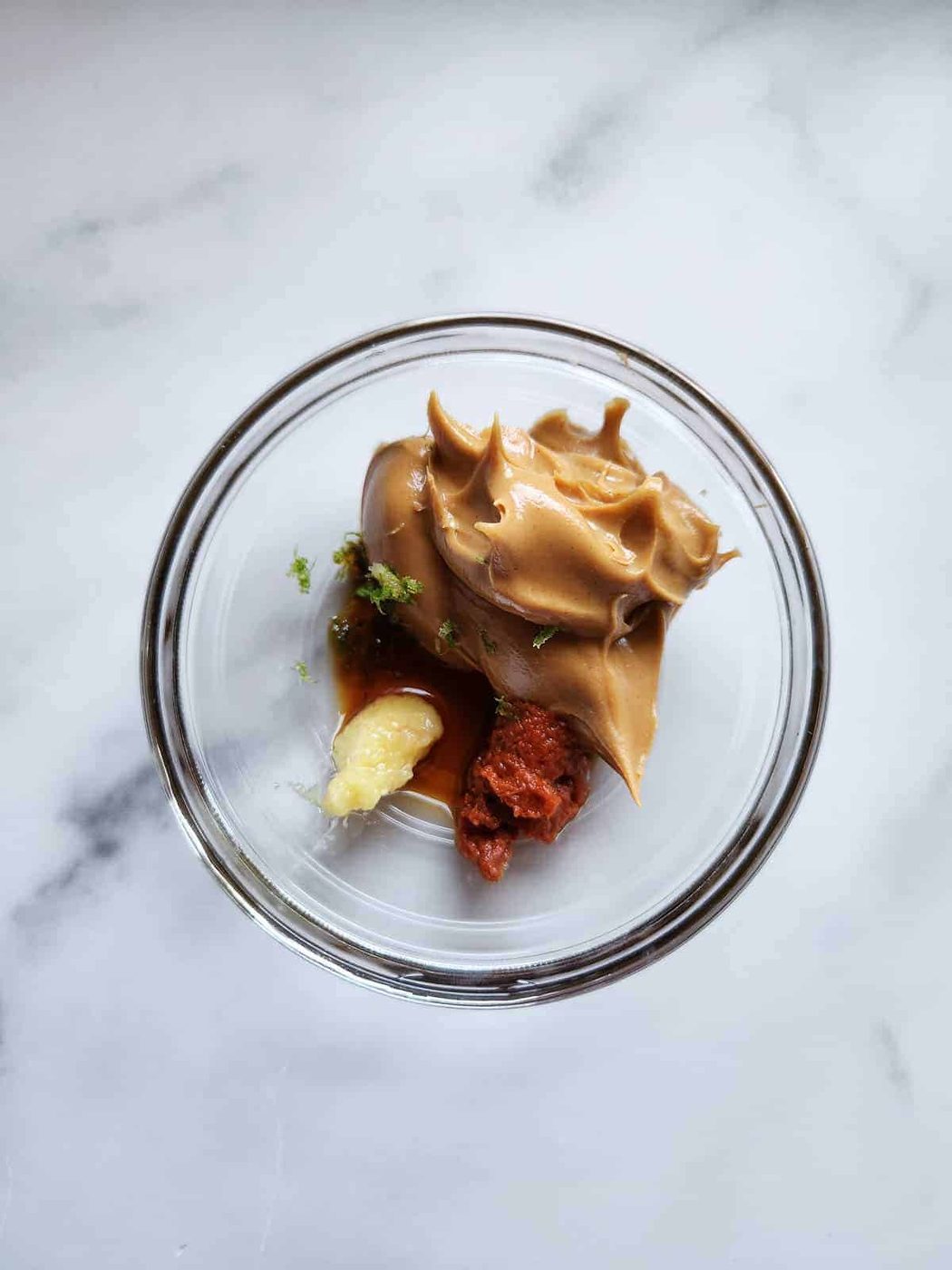 Thai peanut butter in a clear bowl.