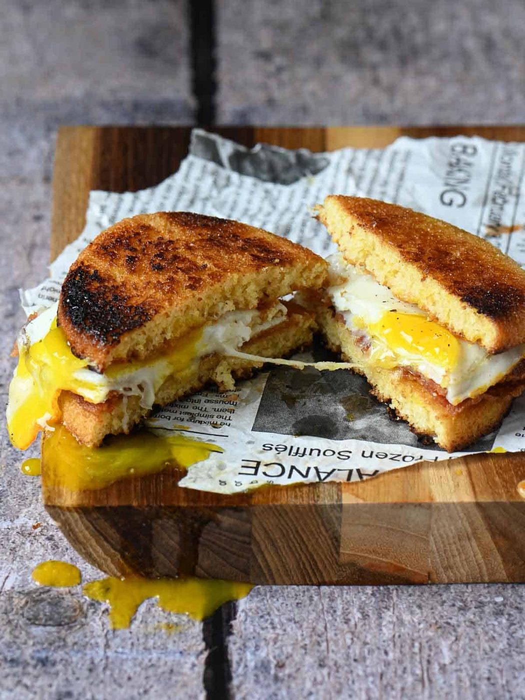 Toaster cake breakfast sandwich split open on a cutting board.