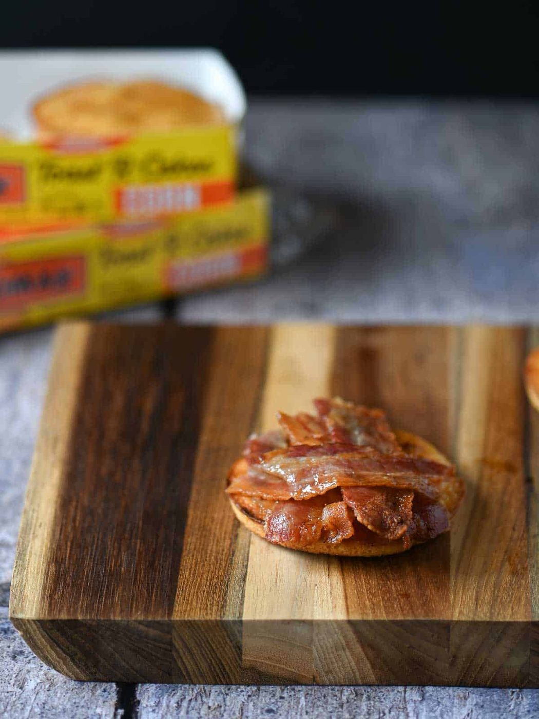 Cooked bacon on a toaster cake.