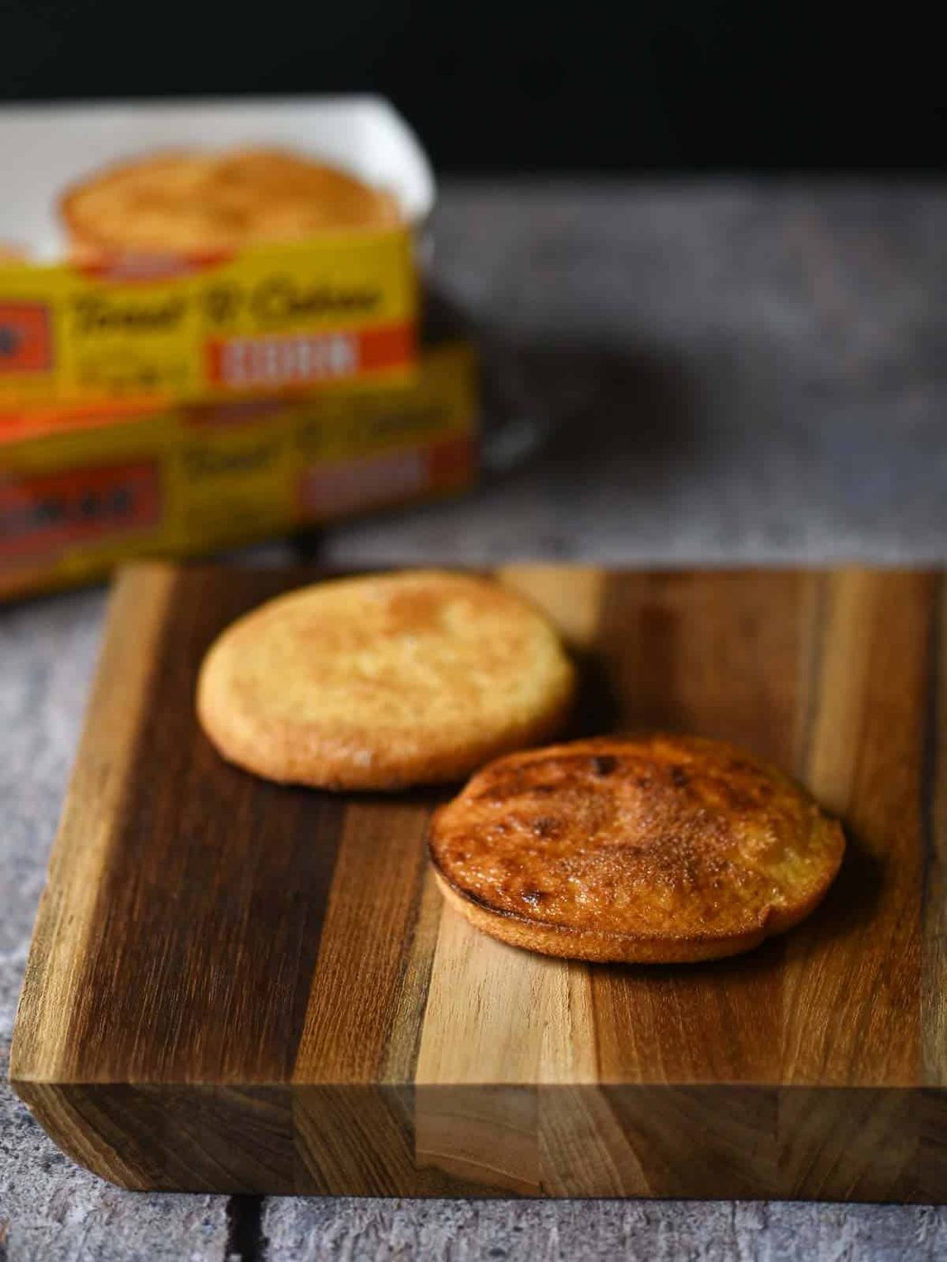 Two tasted toaster cakes on a wooden board.