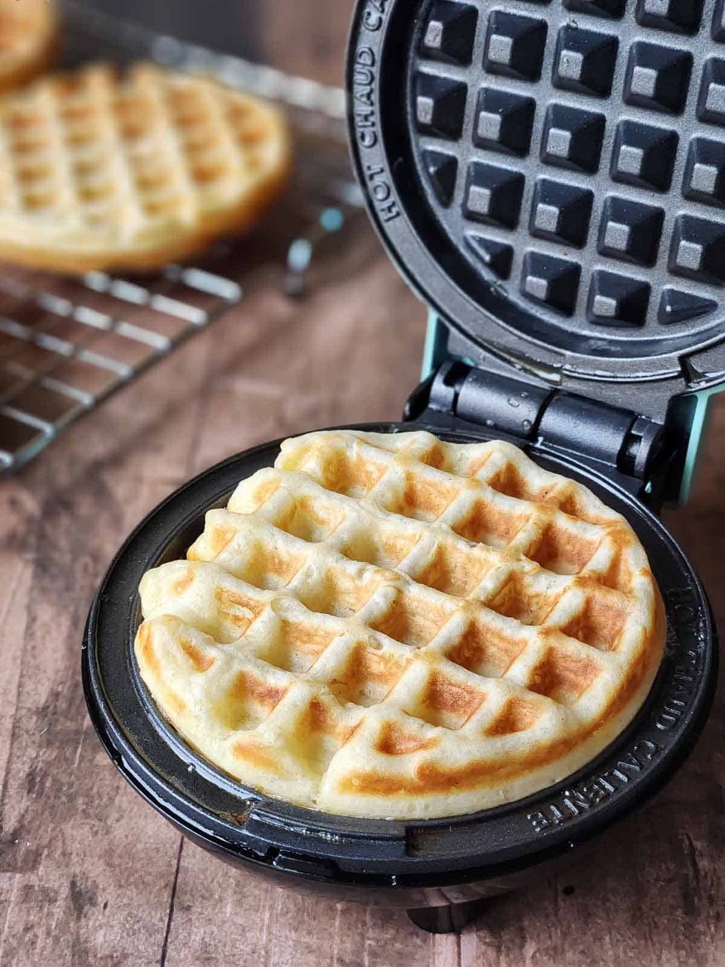 Cooked waffle shown in a mini waffle maker.