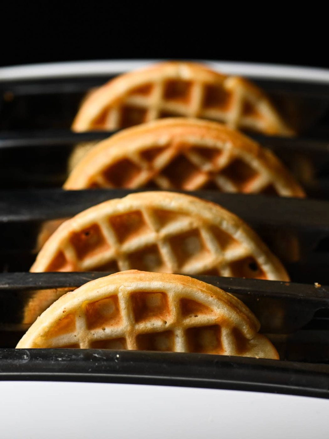 Four waffles in a toaster.