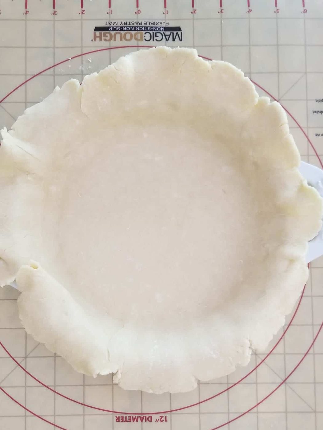 Unbaked pie dough draped in a pie plate