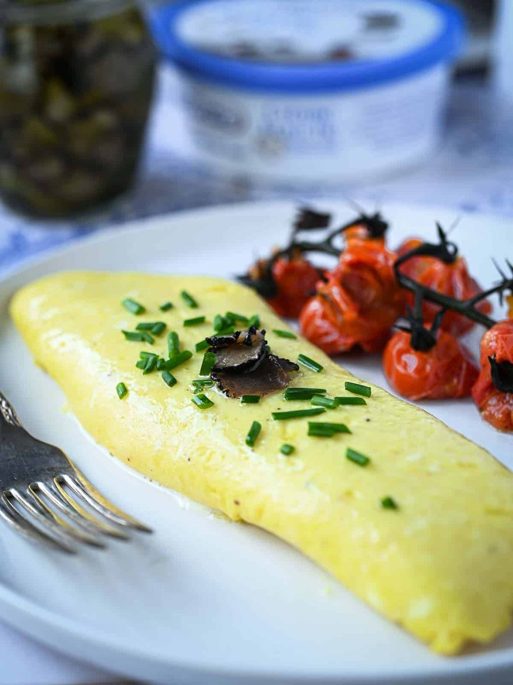 Close-up of a truffle omelet on white plate.