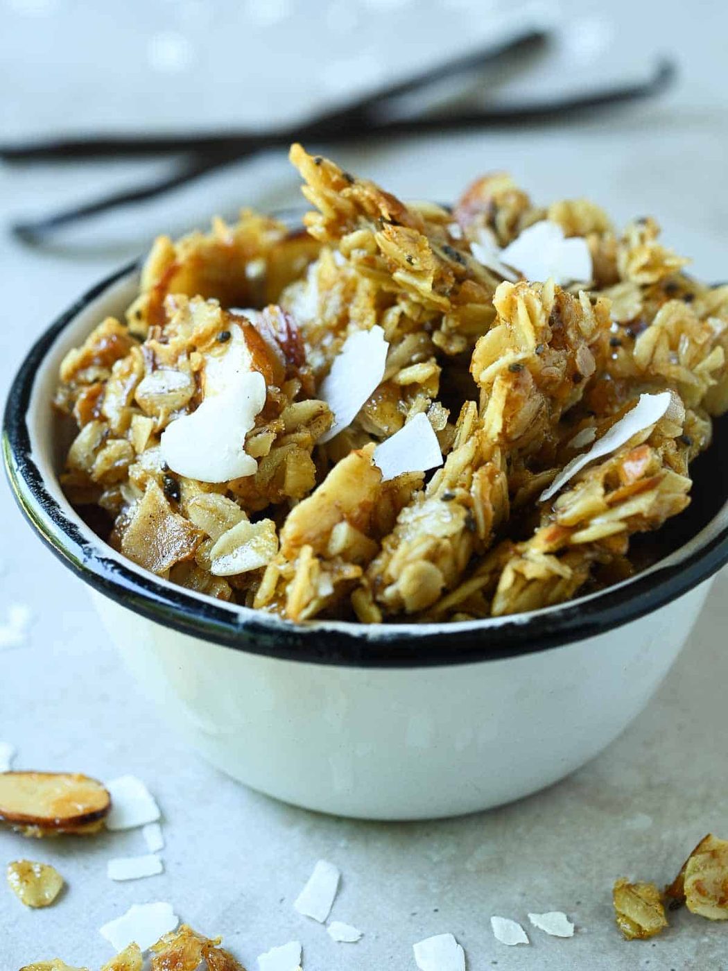 Close-up of vanilla coconut granola in a white cup.