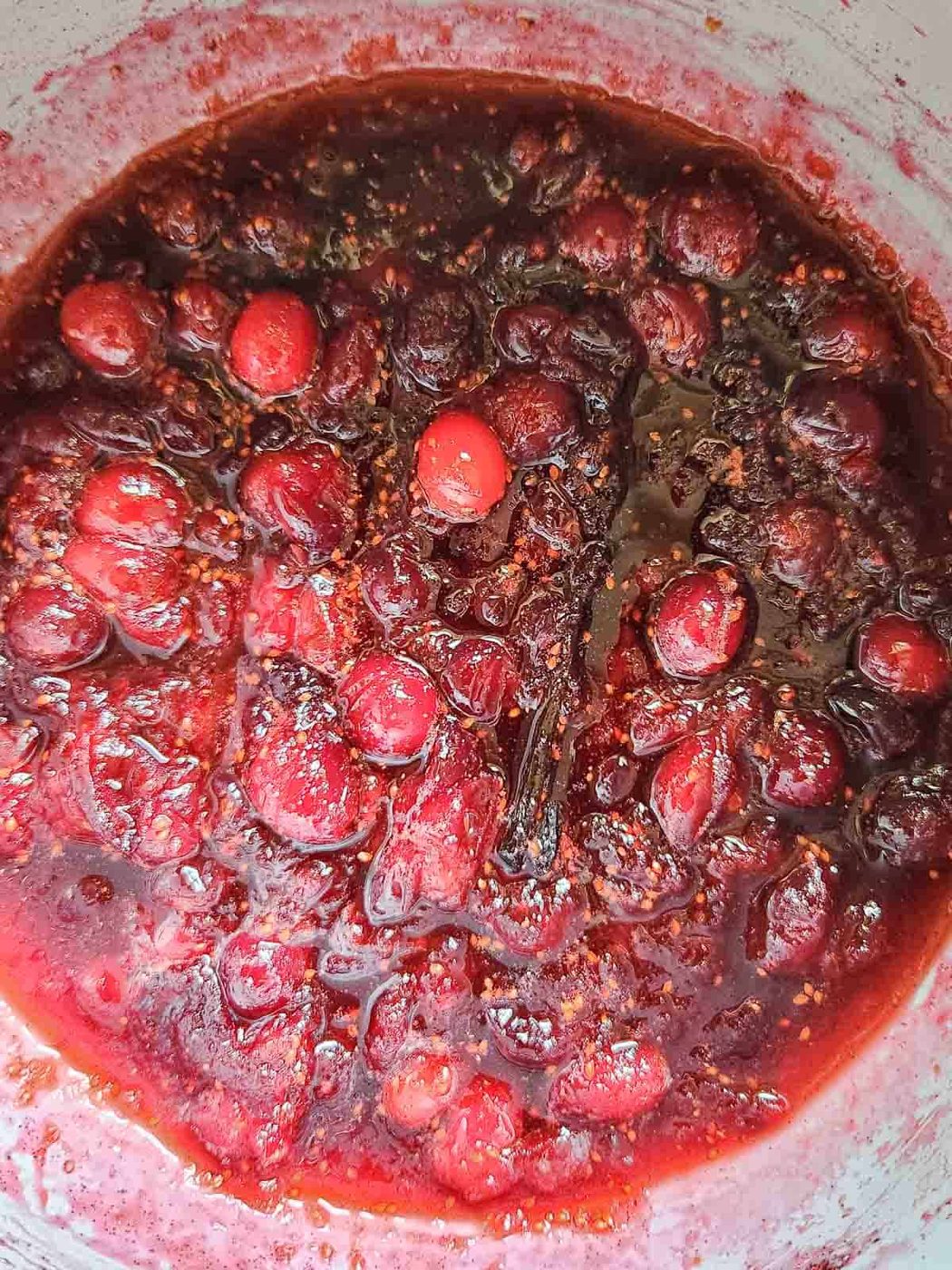 Overhead of cranberry compote in a pot.