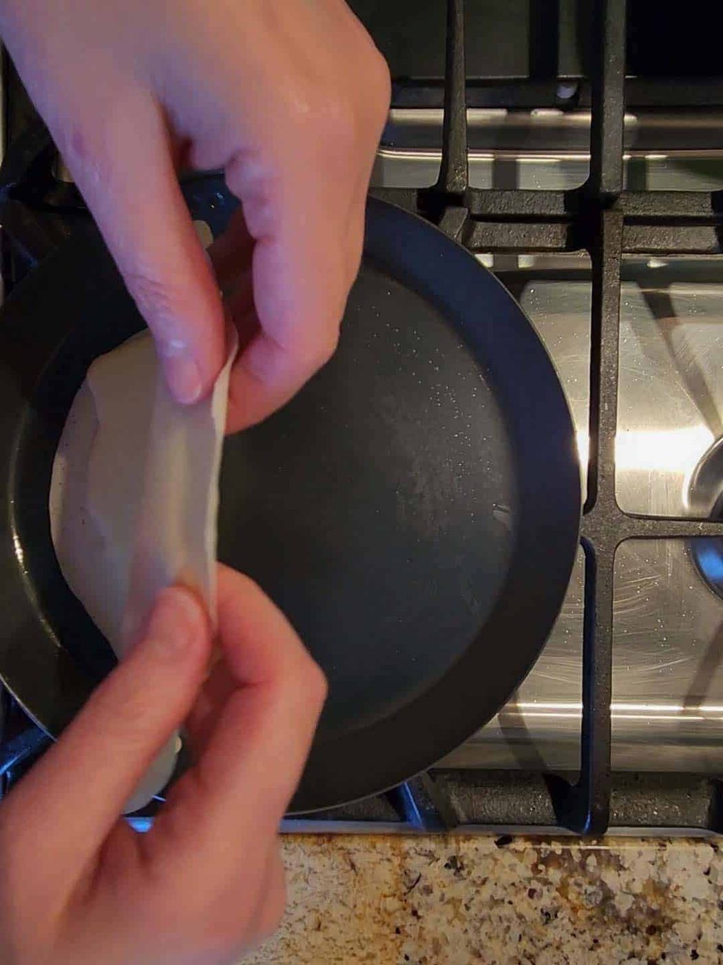 Flipping lemon ricotta crepes with hands.