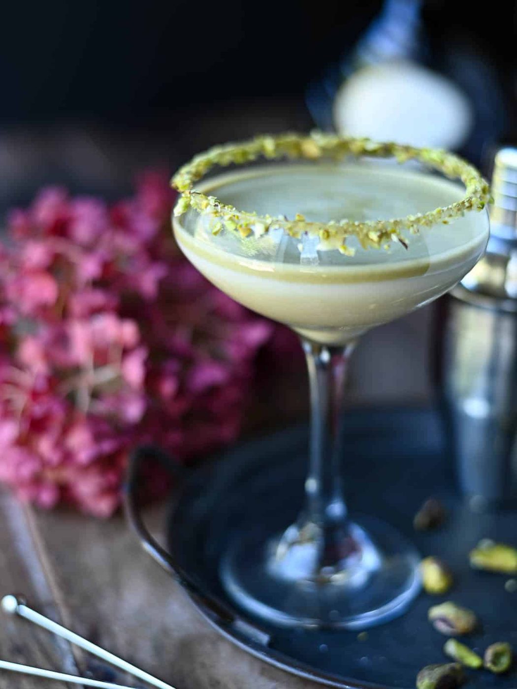 Eye-level view of a pistachio white chocolate martini on a tray.