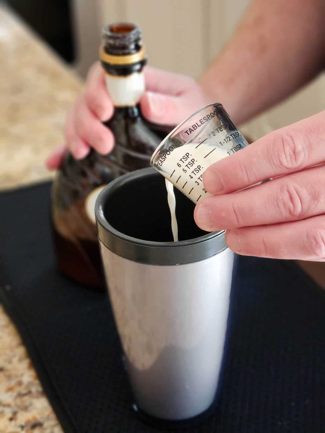 Liqueur being poured into a cocktail shaker.