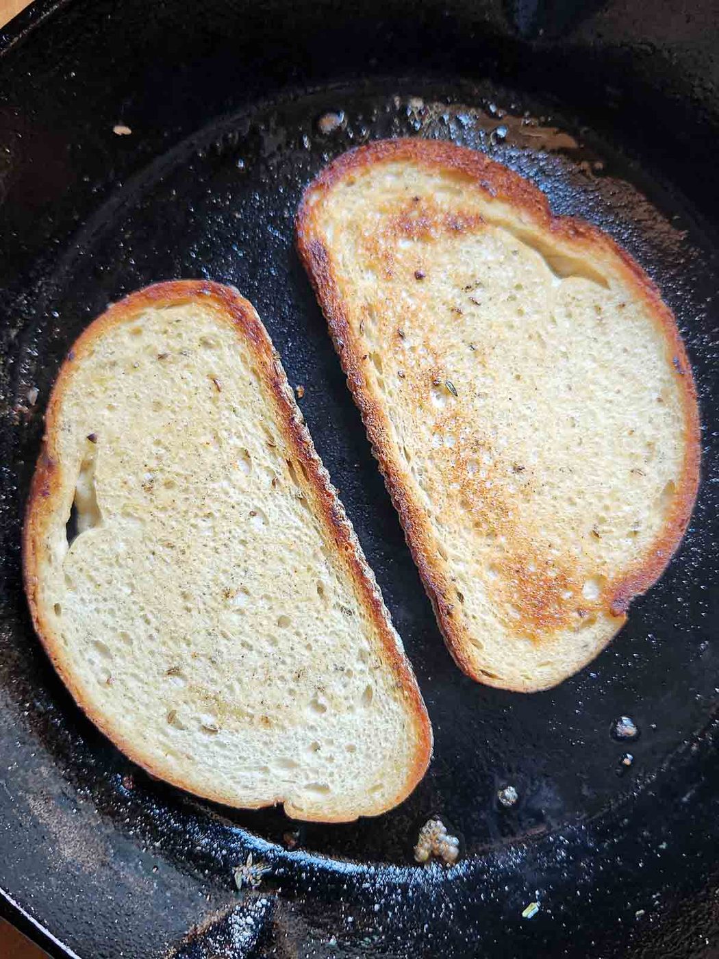 Toasted bread in a black skillet.