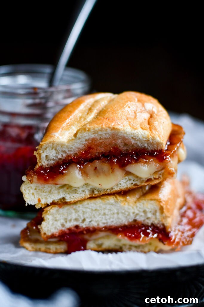 Cheesy perfection: Brie Grilled Cheese with a twist of Bacon and Strawberry Jam. A culinary delight.