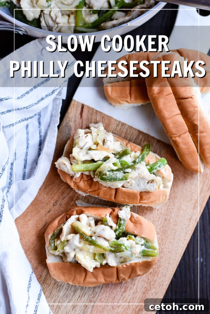 Delicious chicken philly cheesesteak sandwich overflowing with melted cheese, chicken, onions, and peppers.